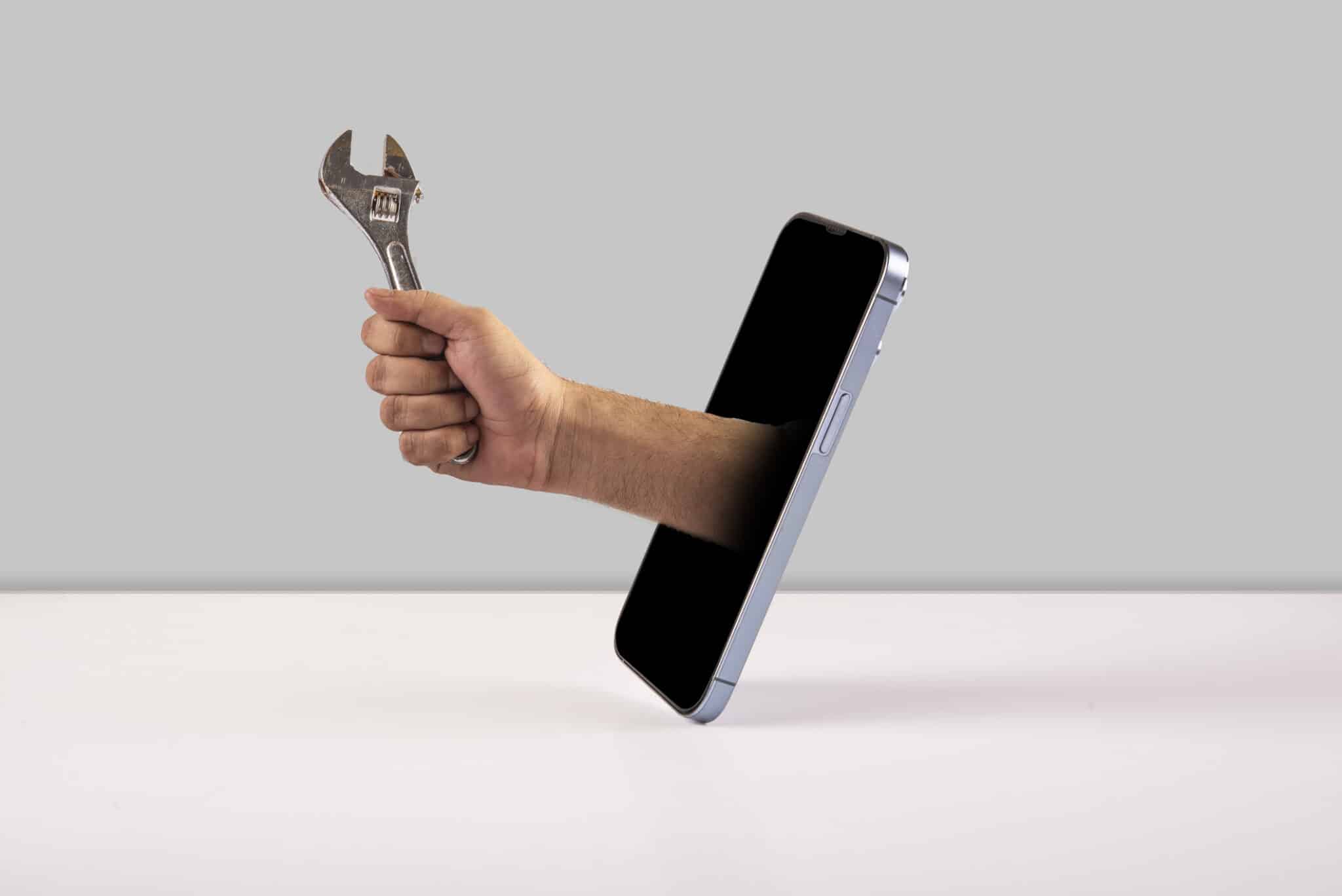 Mobile Smart Plumbing Repairing services with hand holding spanner wrench.